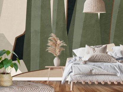 Green Abstract Wallpaper, as seen on the wall of this cozy earthy bedroom, is a geometric mural with dark green abstract shapes on a beige background from About Murals
