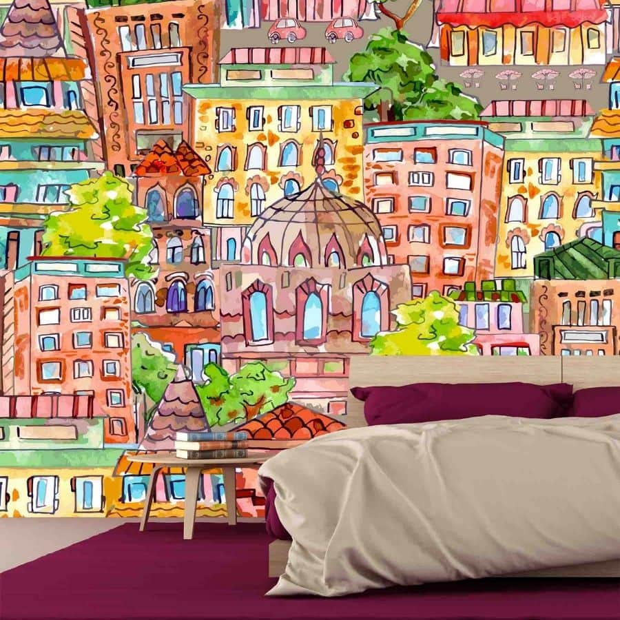 Kids City Wallpaper, as seen on the wall of this bedroom, features a colorful city of buildings, restaurants, cafes and shops from About Murals.