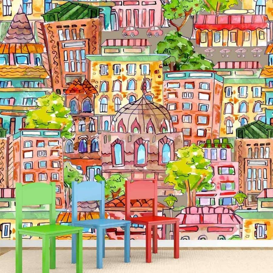 Kids City Wallpaper, as seen on the wall of this playroom, is a mural with a watercolor city of buildings, restaurants, cafes, stores and museums from About Murals.