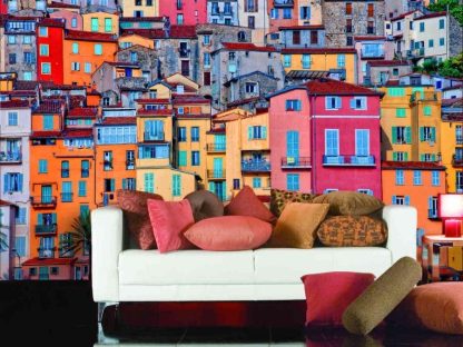 Menton Wallpaper, as seen on the wall of this living room, is a photo mural of colorful houses in the Cote d'Azur, French Riviera from About Murals.