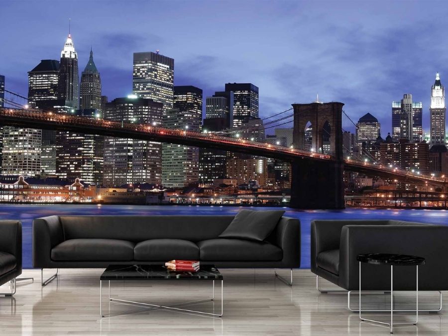 NYC Skyline Wallpaper, as seen on the wall of this black living room, is a photo mural of the Brooklyn Bridge under a blue night sky from About Murals.