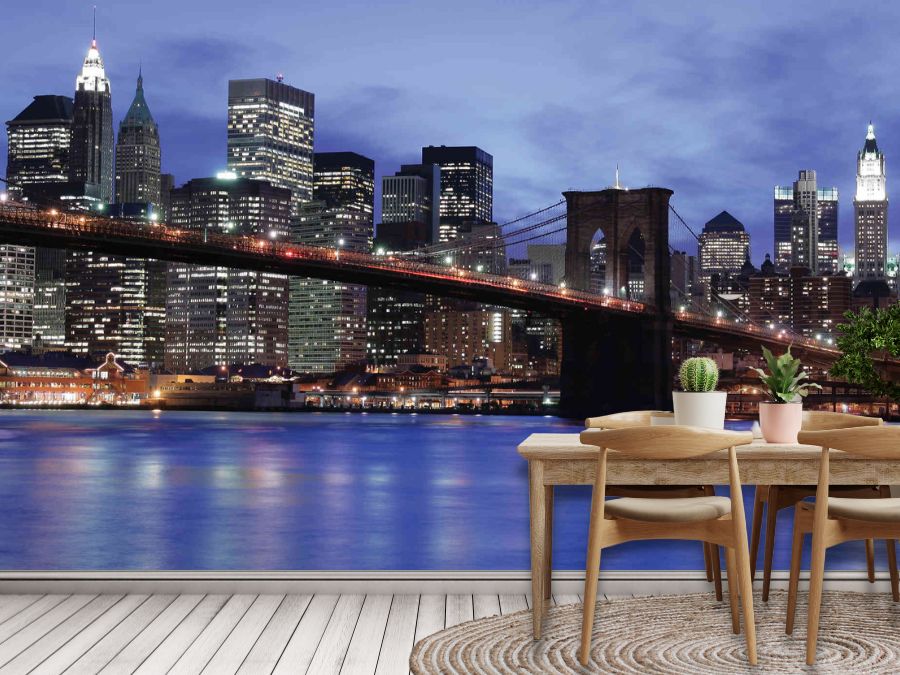 NYC Skyline Wallpaper, as seen on the wall of this kitchen, is a photo mural of high rise buildings, skyscrapers and the Brooklyn Bridge in New York City under a dark blue night sky from About Murals.