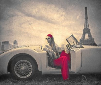 Paris Fashion Wallpaper is a red and sepia mural of a Parisian woman sitting in a vintage car under the Eiffel Tower in France from About Murals.