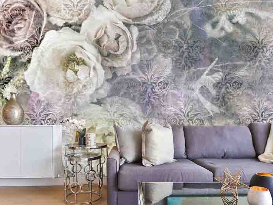 Pastel Rose Wallpaper, as seen on the wall of this living room, is a floral mural with pink and white flowers on a light purple damask background from About Murals.