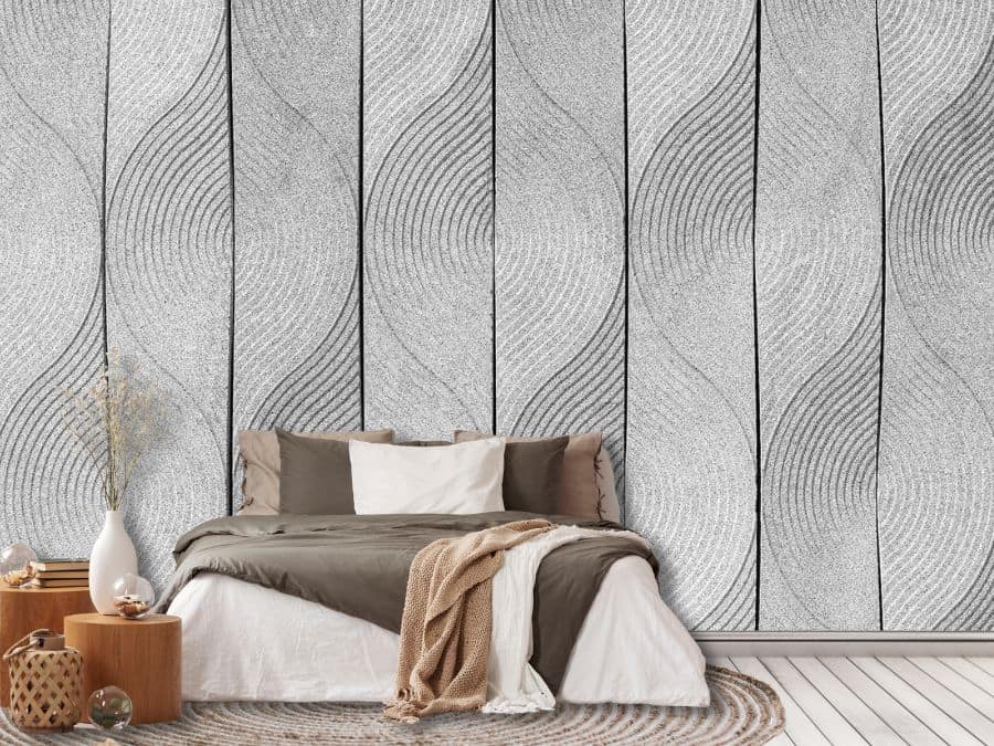 Scandi Leaf Wallpaper, as seen on the wall of this bedroom, is a wall mural with a simple leaf pattern raked into grey zen sand from About Murals.