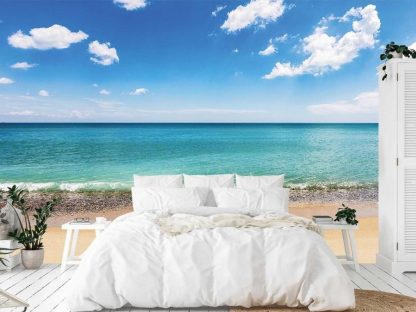 Beach Scene Wallpaper, as seen on the wall of this ocean themed bedroom, is a photo mural of a Black Sea beach from About Murals.