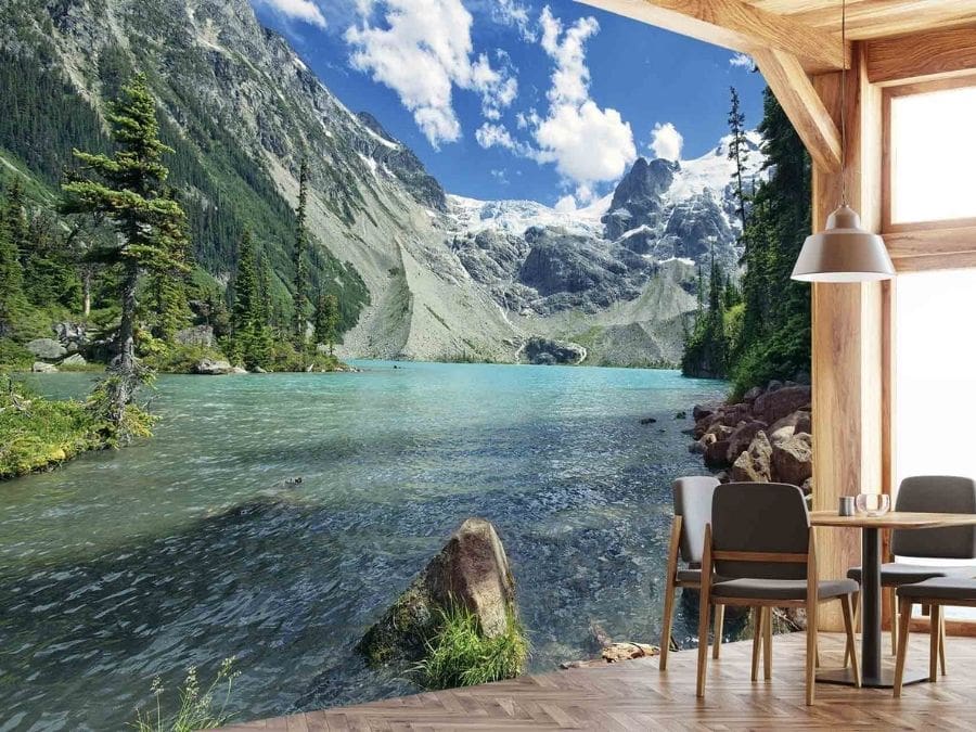 British Columbia Wallpaper, as seen on the wall of this chalet, is a photo mural of Canadian mountains towering over a blue lake in Joffre Lakes, BC from About Murals.