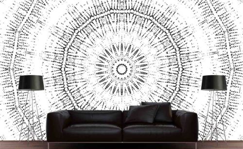 Circle Wallpaper, as seen on the wall of this living room, is a mural of a black and white geometric circle in an almost kaleidoscope pattern from About Murals.