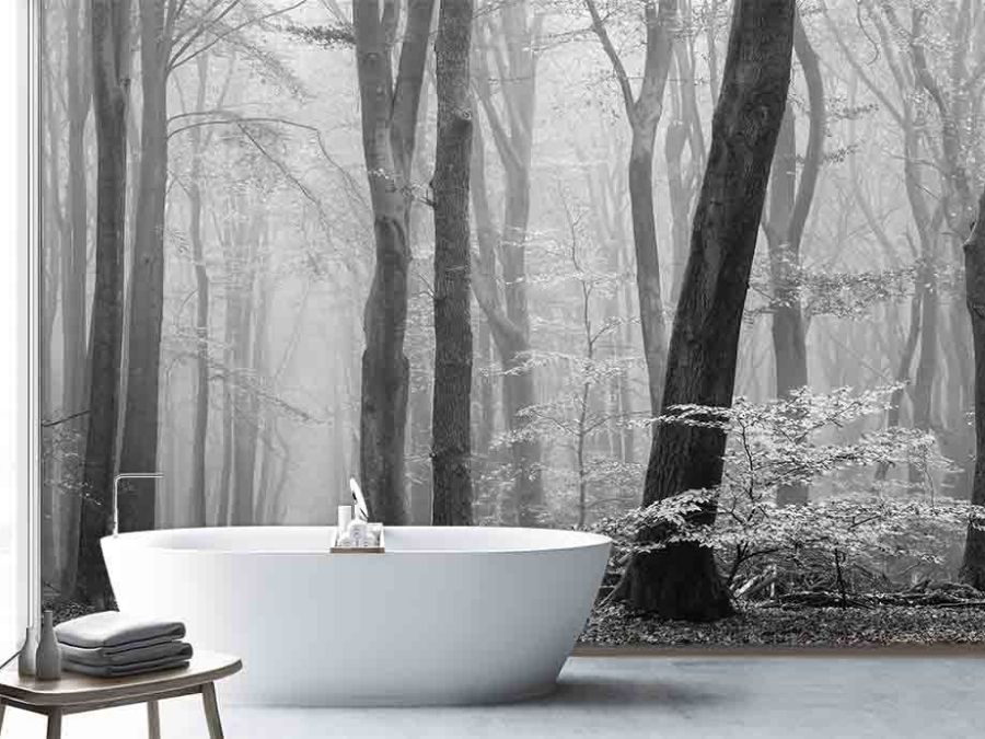 Grey Fog Wallpaper, as seen on the wall of this bathroom, is a black and white photo mural of trees in a misty forest from About Murals.
