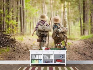 Kids Hiking Wallpaper, as seen on the wall of this playroom, is a photo mural of two children walking on a forest trail with camping gear from About Murals.