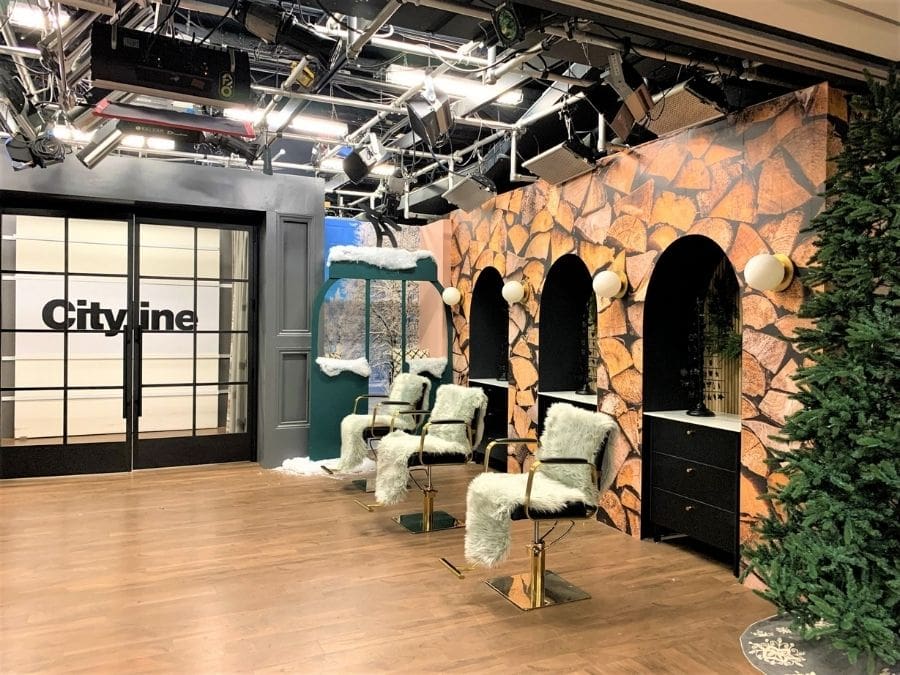 Log Wallpaper, as seen on set at Cityline in Toronto, is a photo mural of stacked logs from About Murals.