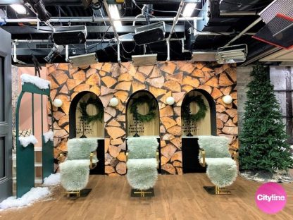 Log Wallpaper, as seen on the wall of the beauty salon at the Cityline Studio, is a photo mural of cut, stacked wood from About Murals.