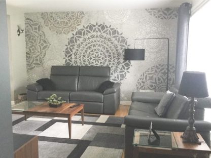Mandala Wallpaper, as seen on the wall of this living room, is a zen mural with grey flower circles from About Murals.