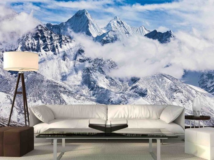 Mount Everest Wallpaper, as seen on the wall of this mountain themed living room, is a photo mural of cloudy, snow capped mountains in Nepal from About Murals.