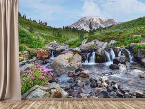 Mt Rainier Wallpaper, as seen on the wall of this room, is a photo mural of a snowy mountain towering over a wildflower meadow and stream from About Murals.