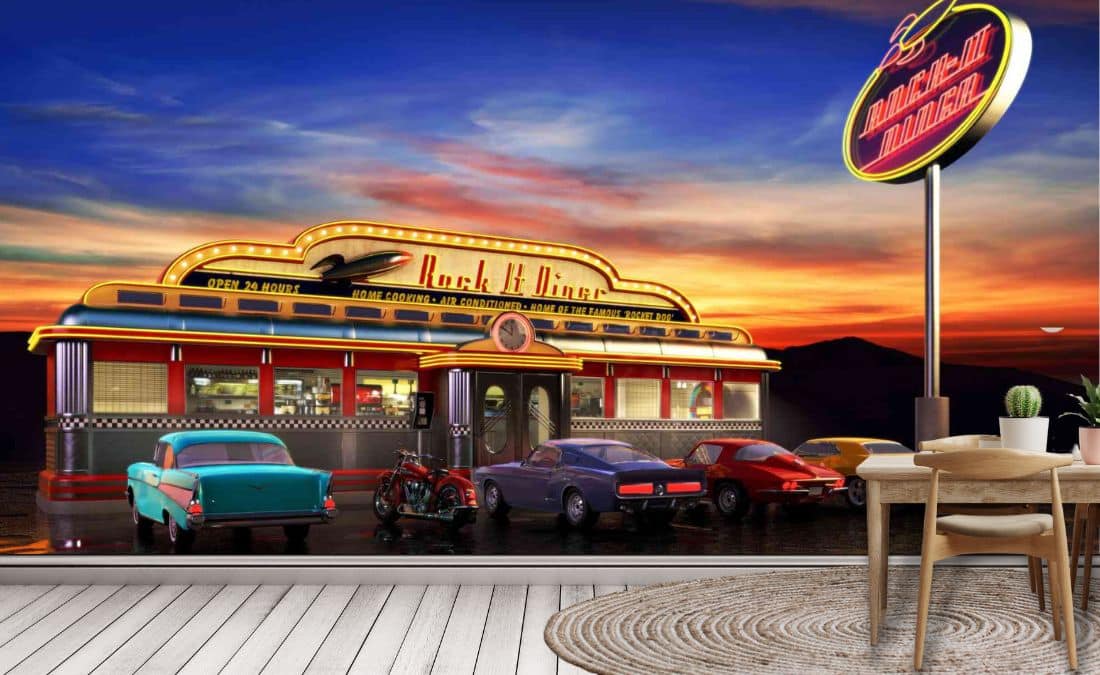 Retro Diner Wallpaper, as seen on the wall of this kitchen, is a mural with classic cars parked at a 50s themed American restaurant called the Rock It Diner from About Murals.