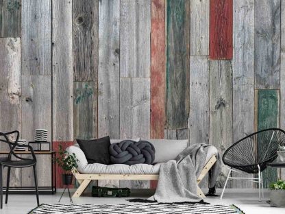 Rustic Wood Wallpaper, as seen on the wall of this grey farmhouse living room, is a realistic photo mural with grey, red and green wooden planks full of texture from About Murals.