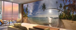 Sunny Beach Wallpaper, as seen on the wall of this ocean themed living room, is a large photo mural of Koh Mak Beach in Thailand from About Murals.