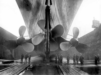 Titanic Wallpaper is a vintage photo mural of engineers inspecting the propellers of the real RMS Titanic ship from below from About Murals.