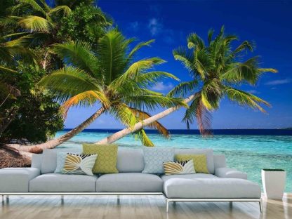 Tropical Beach Wallpaper, as seen on the wall of this palm tree themed living room, is a photo mural of trees over a blue ocean in the Maldives from About Murals.