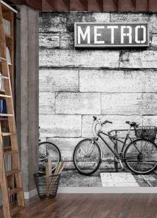 Bicycle Wallpaper, as seen on the wall of this room, is a black and white photo mural of a bike leaning against a wall under a Paris subway metro sign from About Murals.