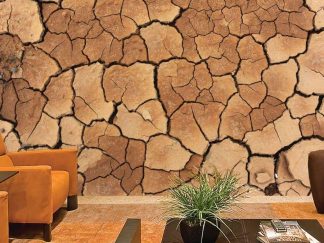 Dirt Wallpaper, as seen on the wall of this living room, is a photo mural of brown cracked earth from About Murals.
