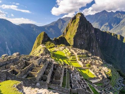Machu Picchu Wallpaper is a photo mural of dry stone ruins of the Incan city against a green mountain in South America from About Murals.
