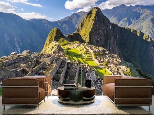 Machu Picchu Wallpaper, as seen on the wall of this living room, is a photo mural of the beautiful Inca citadel against a mountain ridge in Peru from About Murals.
