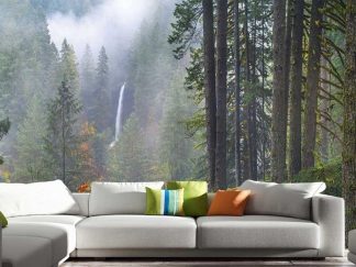 Oregon Forest Wallpaper, as seen on the wall of this living room, is a photo mural of a waterfall in a foggy forest of pine trees from About Murals.