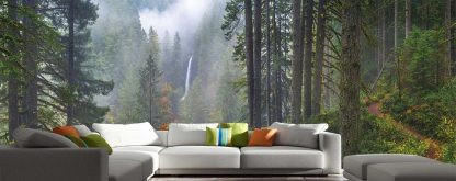 Oregon Forest Wallpaper, as seen on the wall of this living room, is a photo mural of a waterfall in a foggy forest of pine trees from About Murals.