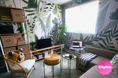 Tropical Leaf Wallpaper, as seen on this apartment wall on an episode of Cityline, is a removable wall mural with green leaves on a white background from About Murals.