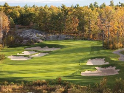 Fall Golf Wallpaper is a photo mural of orange trees towering over a green golf course in Muskoka, Ontario from About Murals.