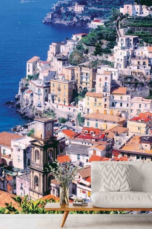 Amalfi Coast Wallpaper, as seen on the wall of this living room, is a photo mural of a beautiful coastal village in Italy overlooking the sea from About Murals.