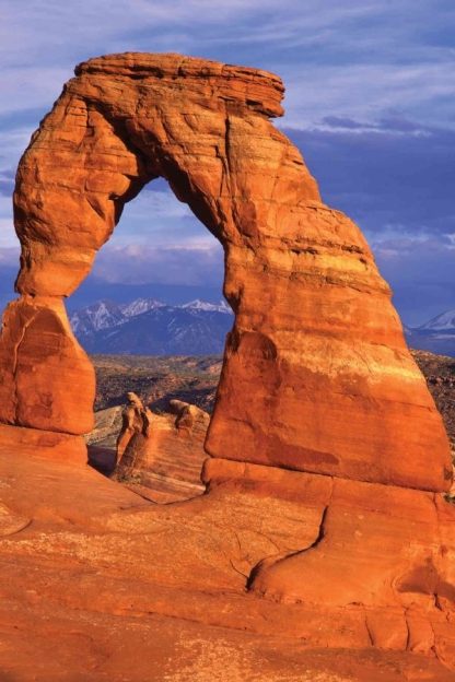 Arches National Park Wallpaper is a photo wall mural of rugged red rock overlooking mountain ranges in Utah from About Murals.