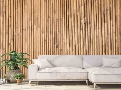 Bamboo Wood Wallpaper, as seen on the wall of this living room, is a mural with vertical bamboo stems that create a natural texture from About Murals.