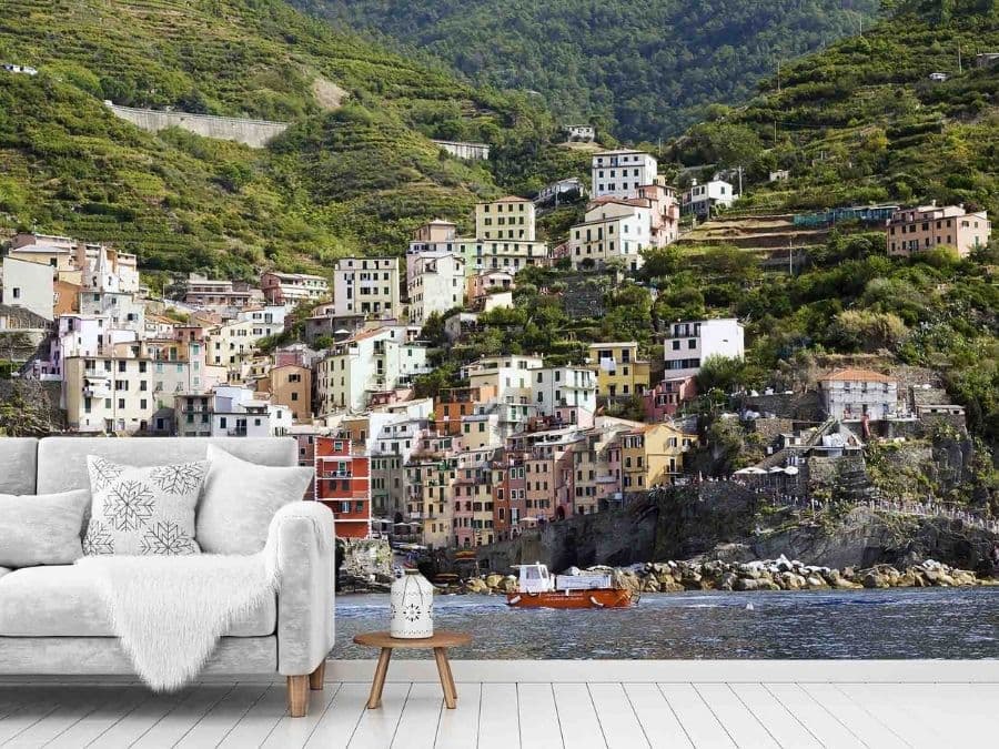 Cinque Terre Wallpaper, as seen on the wall of this living room, is a photo mural of the village of Riomaggiore in Italy from About Murals.