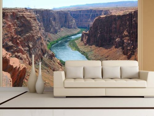 Colorado River Wallpaper, as seen on the wall of this living room, is a photo mural of the water flowing through a canyon from About Murals.