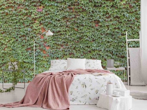 Ivy Wallpaper, as seen on the wall of this bedroom, is a high resolution photo mural of green leaves climbing a brick wall from About Murals.