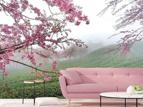 Sakura Wallpaper, as seen on the wall of this living room, is a photo mural of pink cherry blossom trees overlooking a misty tea plantation from About Murals.