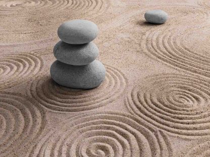 Zen Stone Wallpaper is a photo wall mural of stacked rocks in sand from About Murals.
