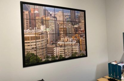 City Window View Wallpaper, as seen on the wall of this customer's office, is a high resolution photo mural of skyscrapers and buildings in downtown Montreal from About Murals.