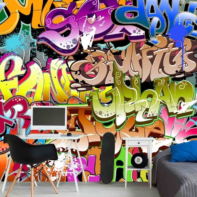 Cool Graffiti Wallpaper, as seen on the wall of this bedroom, is a colorful mural of words like Dance, Music, Urban and Style from About Murals.