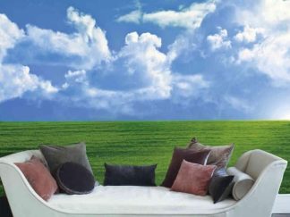 Field Wallpaper, as seen on the wall of this living room, is a photo mural of a cloudy sky in the valley over green grass from About Murals.