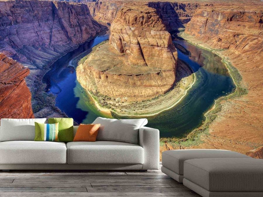 Horseshoe Bend Wallpaper, as seen on the wall of this living room, is a photo mural of the Colorado River meandering through Navajo Sandstone in Arizona from About Murals.