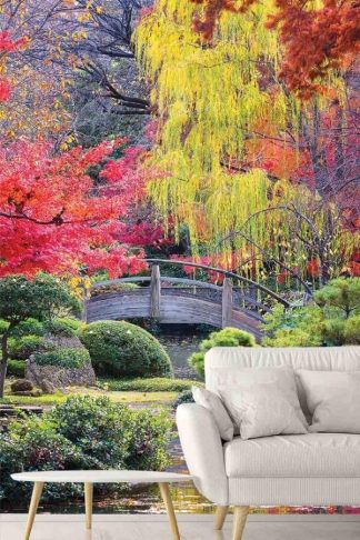 Japanese Bridge Wallpaper, as seen on the wall of this living room, is a photo mural of a zen garden filled with a Japanese maple tree, weeping willow tree and ornamental shrubs overlooking a pond from About Murals.