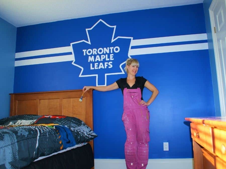 A painted mural in Brantford, ON of the Toronto Maple Leafs logo in a boys hockey themed bedroom created by muralist Adrienne of About Murals.