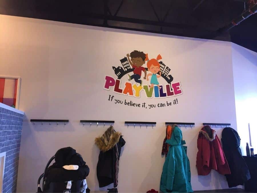 A painted wall mural in Hamilton, ON of Playville's logo by muralist Adrienne Scanlan of About Murals.