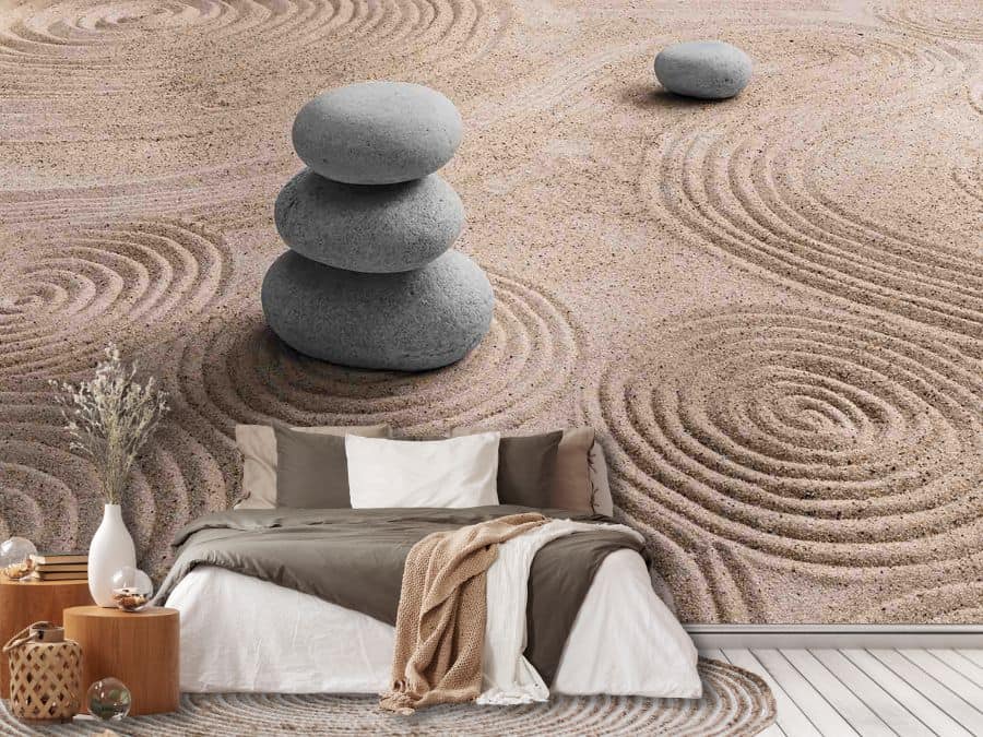Zen Stone Wallpaper, as seen on the wall of this bedroom, is a wall mural with three stacked stones sitting in a dry sand garden with textured circles raked in from About Murals.