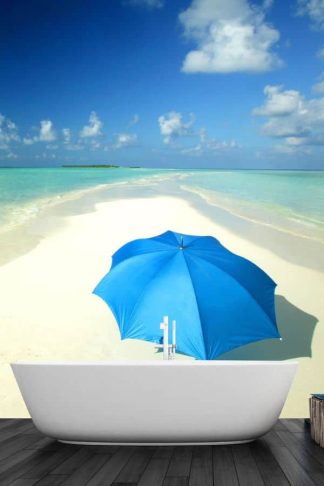 Beach Umbrella Wallpaper, as seen on the wall of this bathroom, is a photo mural of a blue umbrella on a white tropical beach from About Murals.