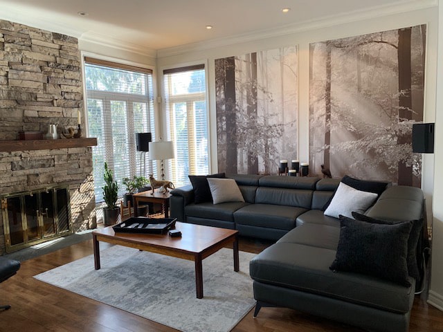 Brown Autumn Wallpaper, as seen on the wall of this neutral living room, is a photo wallpaper of sunshine beaming through a fall forest from About Murals.